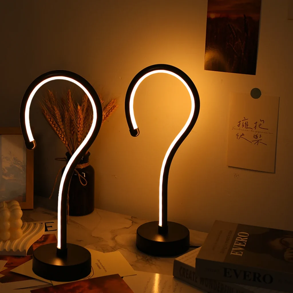 Question Mark LED Table Lamp, set of 2 beside books